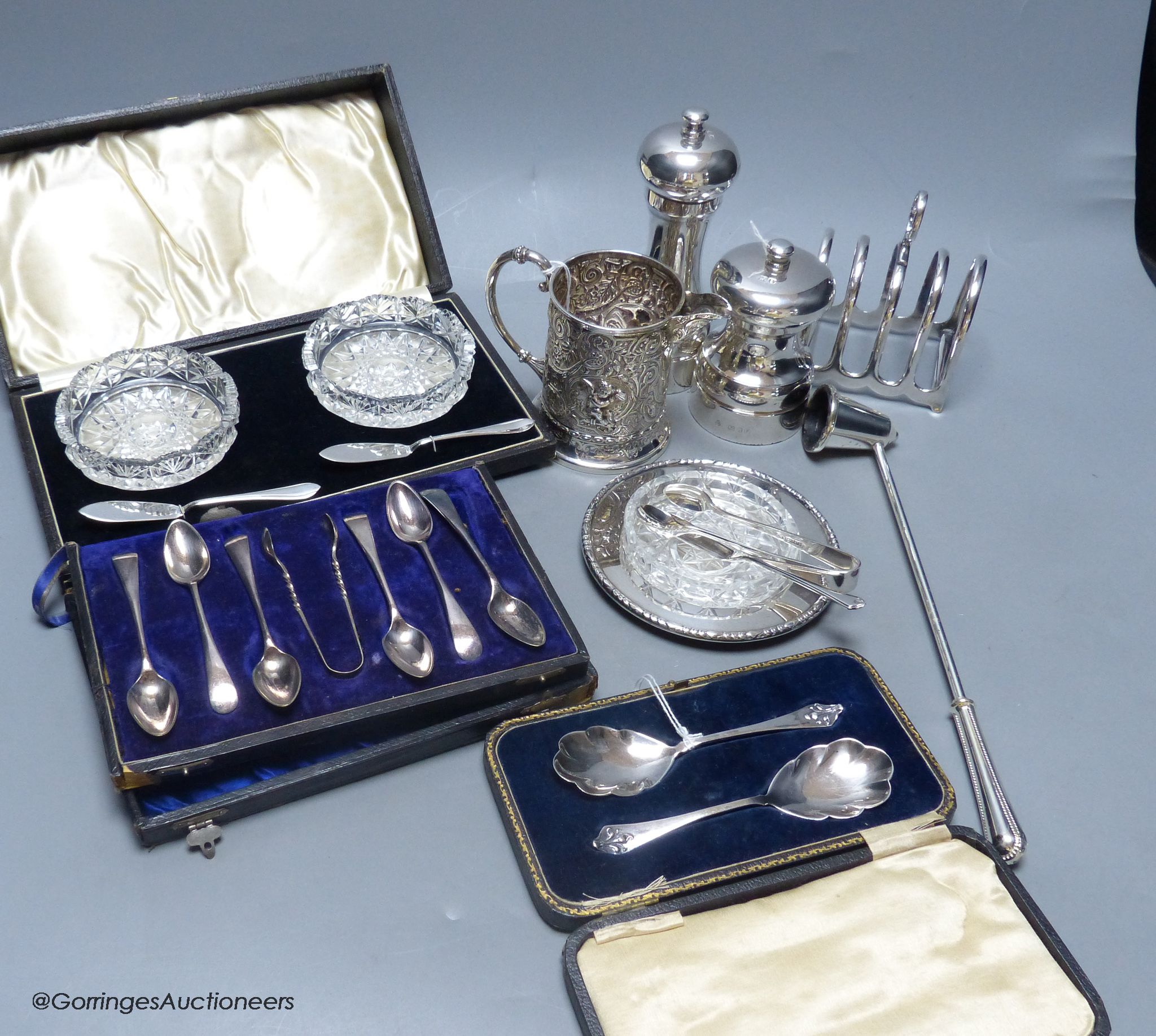 Two silver capstan pepper mills, a cased pair of silver preserve spoons, a Mappin & Webb silver and cut glass butter dish and knife and sundry small plated items